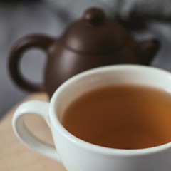 Cup of tean and teapot on wooden heart