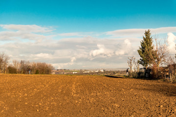 empty field before a sky with clouds