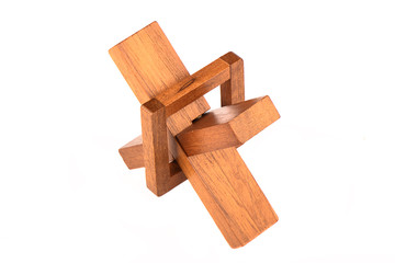 Assembled wooden cross puzzle isolated on a white background.