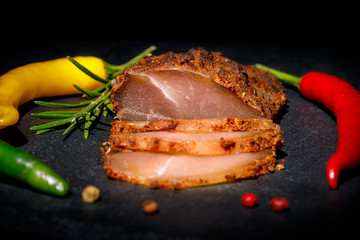 Chicken breast basturma on a black background