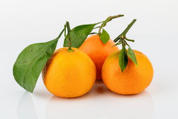 Ripe Mandarin with leaf close-up on white background
