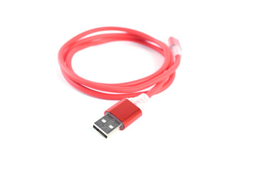Red USB cable for smartphone charge isolated on white background.