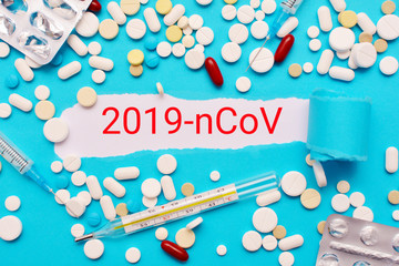 Concept Coronavirus on a blue background with medicines. Novel coronavirus 2019-nCoV, MERS-Cov. Medications for the treatment of coronavirus, seasonal viral and influenza infections. 
