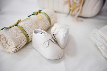 New born white  baptism shoes and  towel