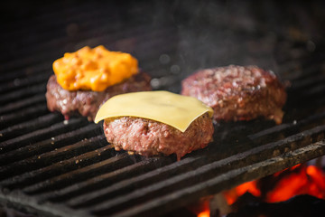 Grilled hamburgers on charcoal coals