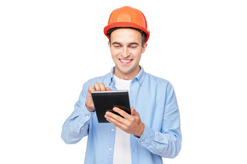 Builder in helmet smiling and uses tablet, isolated background, copy space