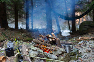 Camp fire with food and coffee and relaxation in nature