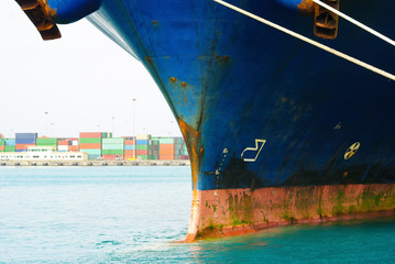 View of very large container ship port bow part. Metal is damaged and rusty.