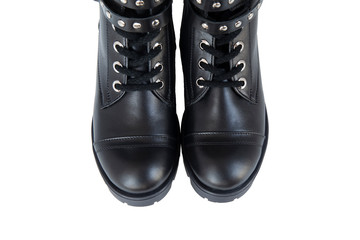 Black leather boots with metal fittings and knobs isolated on white background.