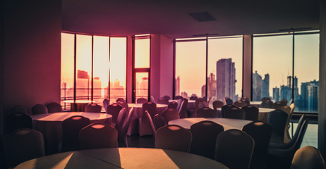 blurry image of empty event  location with city skyline and sunset sky background