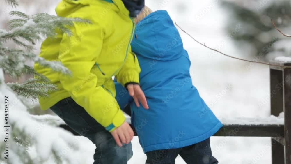 Poster Sweet toddler boy, playing with snow on playground, kid play with snow