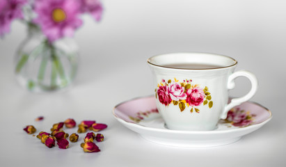 Fototapeta na wymiar A cup of tea with dried roses