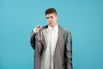 the shirt and jacket of an adult on a young guy look ridiculous