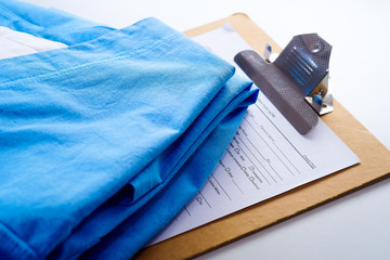 Medical form on a white table near a medical report