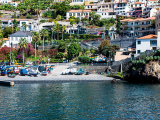 Camara de Lobos is a picturesque fishing village with high cliffs near the city of Funchal Madeira . Winston Churchill loved to paint this village