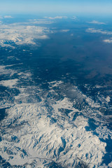 Naklejka premium Winter mountains from the plane window. Turkish mountains landscape aerial view. Snow peaks.