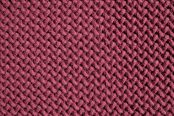 Repeating Machine Knitting Texture of Sweater. Dark red Knitted Background.
