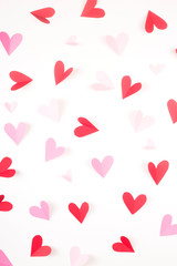 Red and pink hearts made of paper on a white background. Valentine's day and love concept.