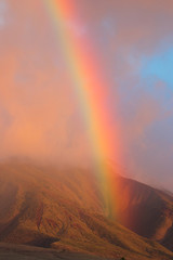 Fiery rainbow at sunset over the west maui mountains.