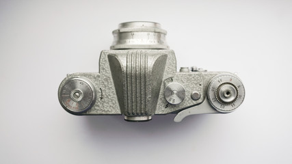 The old Soviet 35mm SLR camera. Retro photo technology on the white background. 