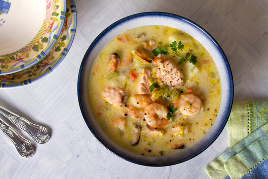 Seafood chowder with salmon, shrimps, crabmeat and mussels. View from above, top view