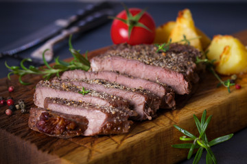 Beef steak fillet with roasted potatoes, rosemary and tomatoes