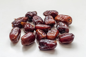 Few dried dates on a light table surface