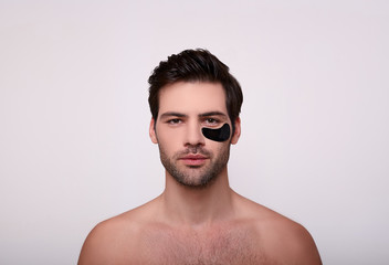 Obraz premium Serious brunette with black patches on her face.