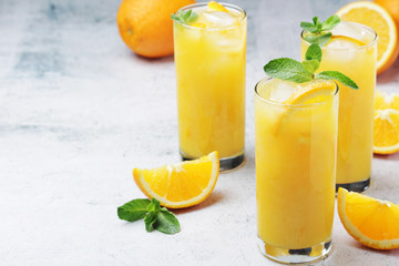 Glasses full of orange juice with ice