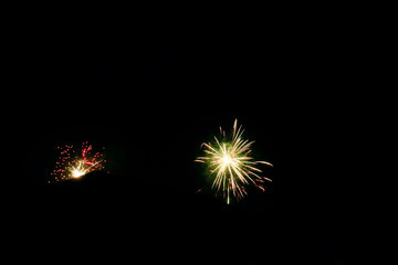 Fireworks explosions on dark background. New Year's Eve celebrations