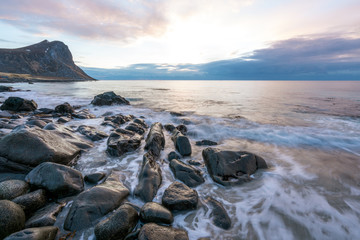 Wet boulders and rocks in Lofoten islands during sunset and blue hours in spring. Long exposure photography. Traveling and explorer concept.