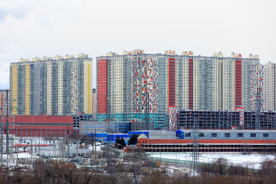 Panorama of the city with multi-storey residential buildings, a motorway, a power station and power lines, in winter © DimaD77