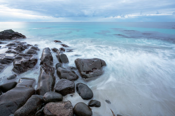 Wet boulders and rocks in Lofoten islands during sunset and blue hours in spring. Long exposure photography. Traveling and explorer concept.
