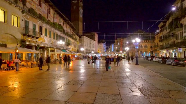 Time lapse of people walking in Piazza delle Erbe, famous city landmark, Verona, Italy.	