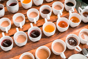 Tasting of different types of coffee and natural teas (ginger, vainilla) on a wooden background in Bali, Indonesia