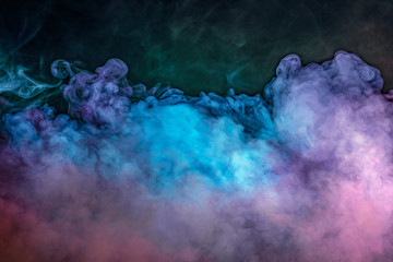 Abstract backlit smoke texture in pink blue purple on black background.