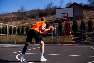 Rear view of basketball player in street court