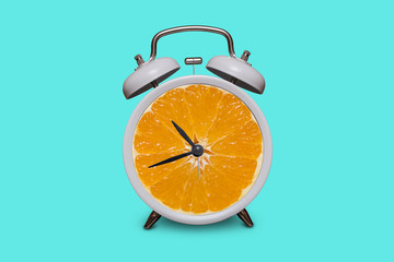 Old fashioned white alarm clock. Orange instead of a dial
