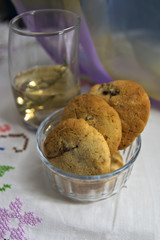 Still life where some cookies with a glass of an infusion in the background