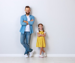 concept of the family. father and child to daughter near empty wall