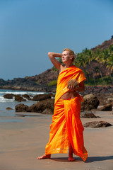 Woman in indian clothing on the beach..