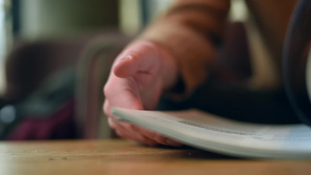 Turning pages of a magazine. Flipping book pages close-up.