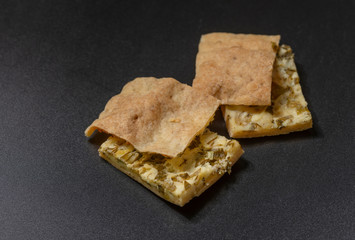  Two pieces of cheese cake are on a black background.
