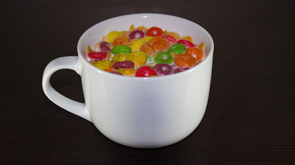 CEREAL WITH MILK, IN A WHITE COLOR RATE, ON A DARK SURFACE