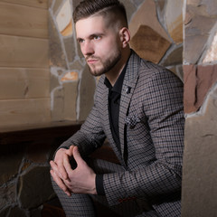 Obraz premium Handsome young elegant man in house interior.