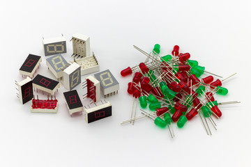 Electronic components. Old 7 segments single digit led display and red and green leds on white background.