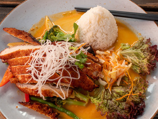 Seasonal vegetables on wok in a juicy teriyaki sauce and fragrant rice in Asia restaurant