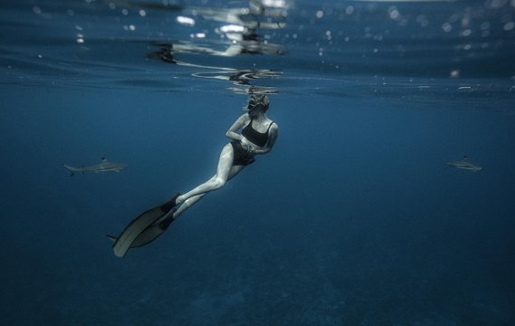 Woman freediving in clear tropical water