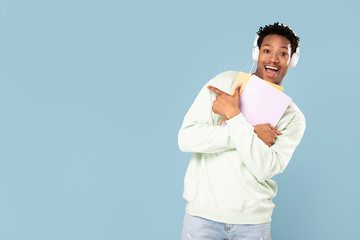 Happy african student posing in studio.