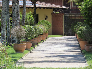 Fototapeta na wymiar Entrance to luxury homes. Path surrounded by grasses